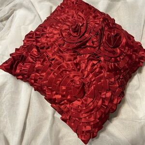 Elegant Red Satin Pillow with Rosette Design